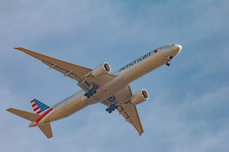A commercial airplane captured in flight against a clear blue sky.